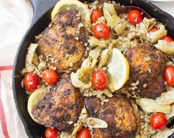 This Greek Lemon Chicken is bursting with flavor from a delicious marinade, cherry tomatoes, artichokes, and a lemon cauliflower rice all made in one pan!